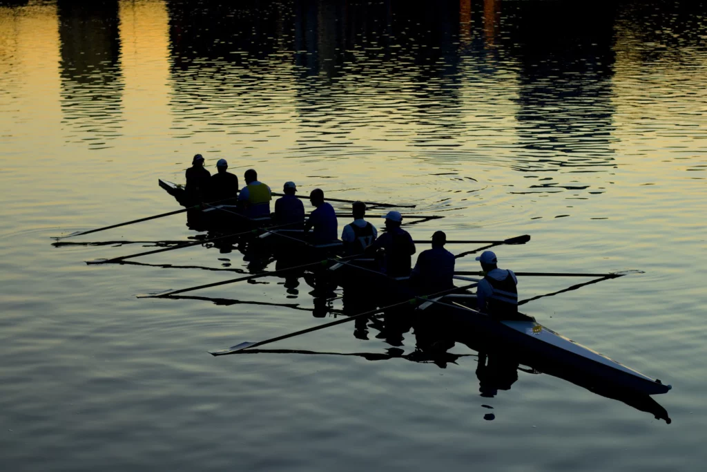 a team rowing on a lake