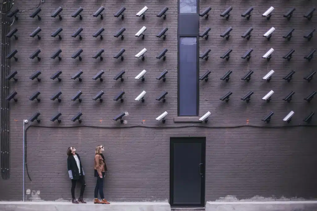 a wall of security camera looking at two individuals